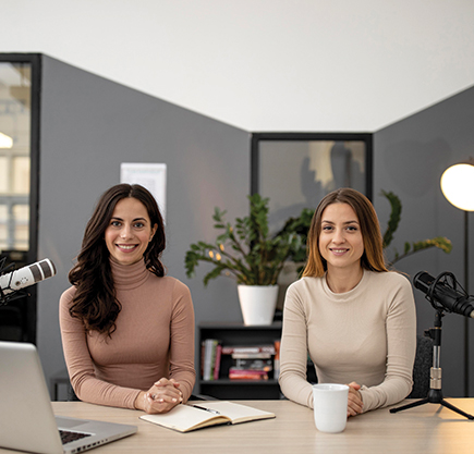 Two women sitting at a table, engaged in conversation Advertising