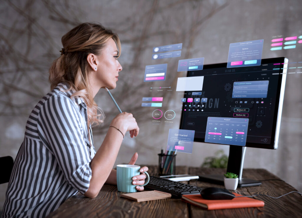 A woman sitting at a desk with a computer screen and a cup of coffee web & development