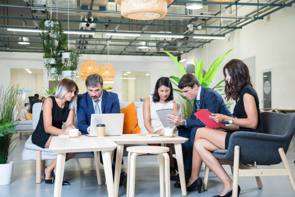 Group of professionals working together at office table with laptop and digital marketing services