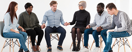 Several individuals seated on chairs in a circular formation during a group discussion Influencer marketing